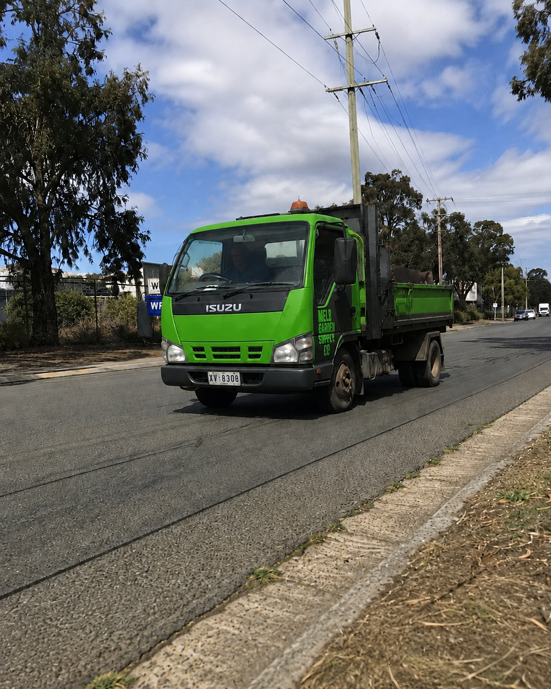 A tip truck leaving the Altona yard loaded for delivery