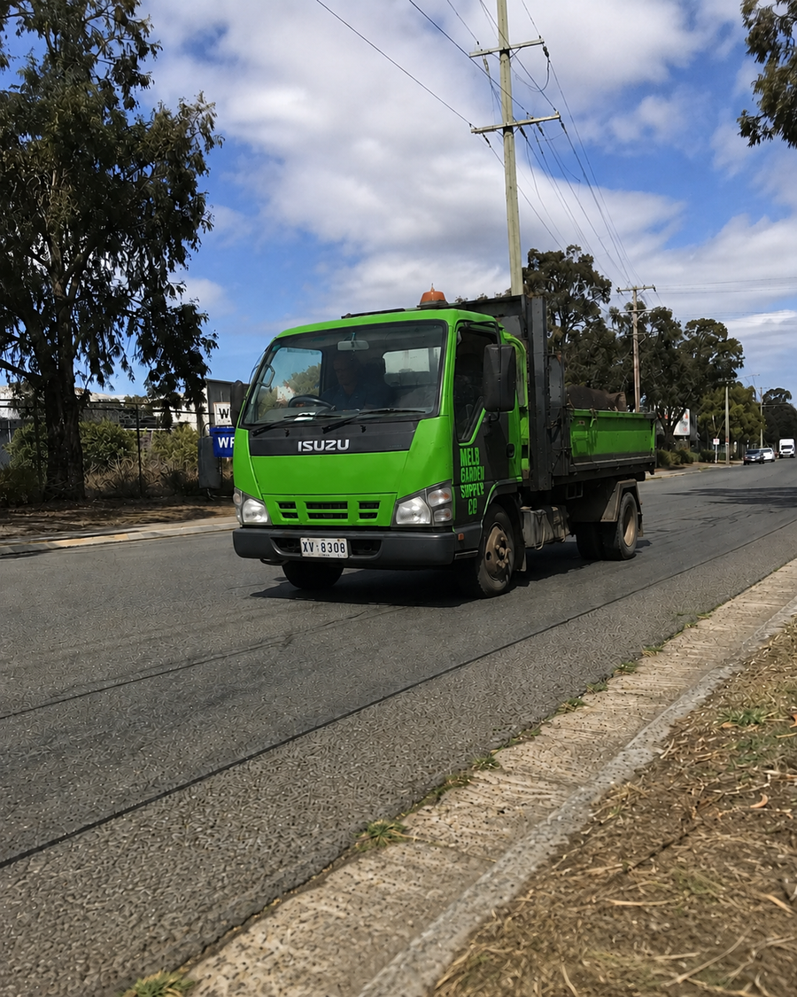 A tip truck leaving the Altona yard loaded for delivery